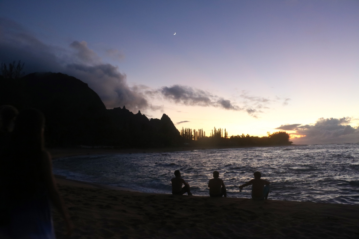 3 people watching the sunset  